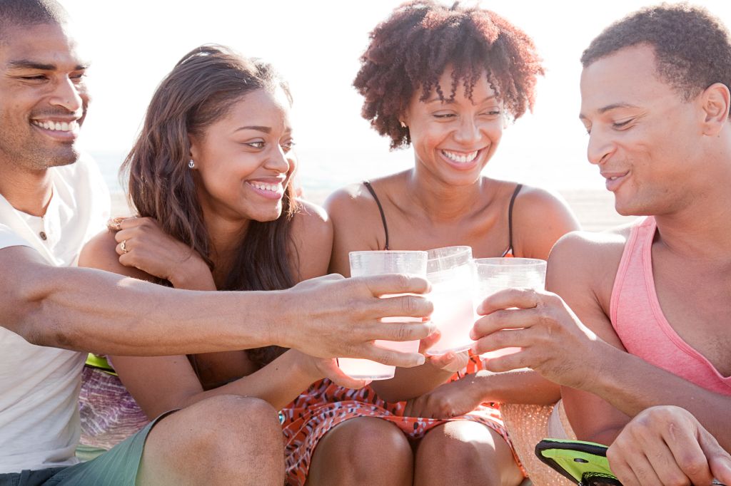 Friends toasting each other on beach