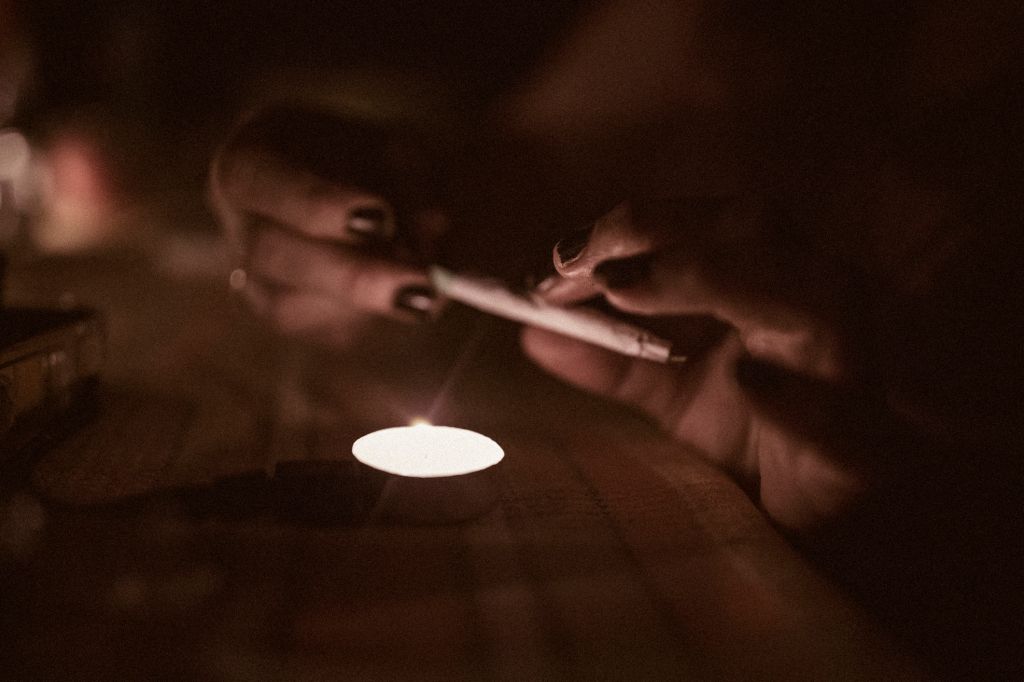 Hands of a 40 year old woman rolling a joint, alternative medicine prescribed for her chronic illness.