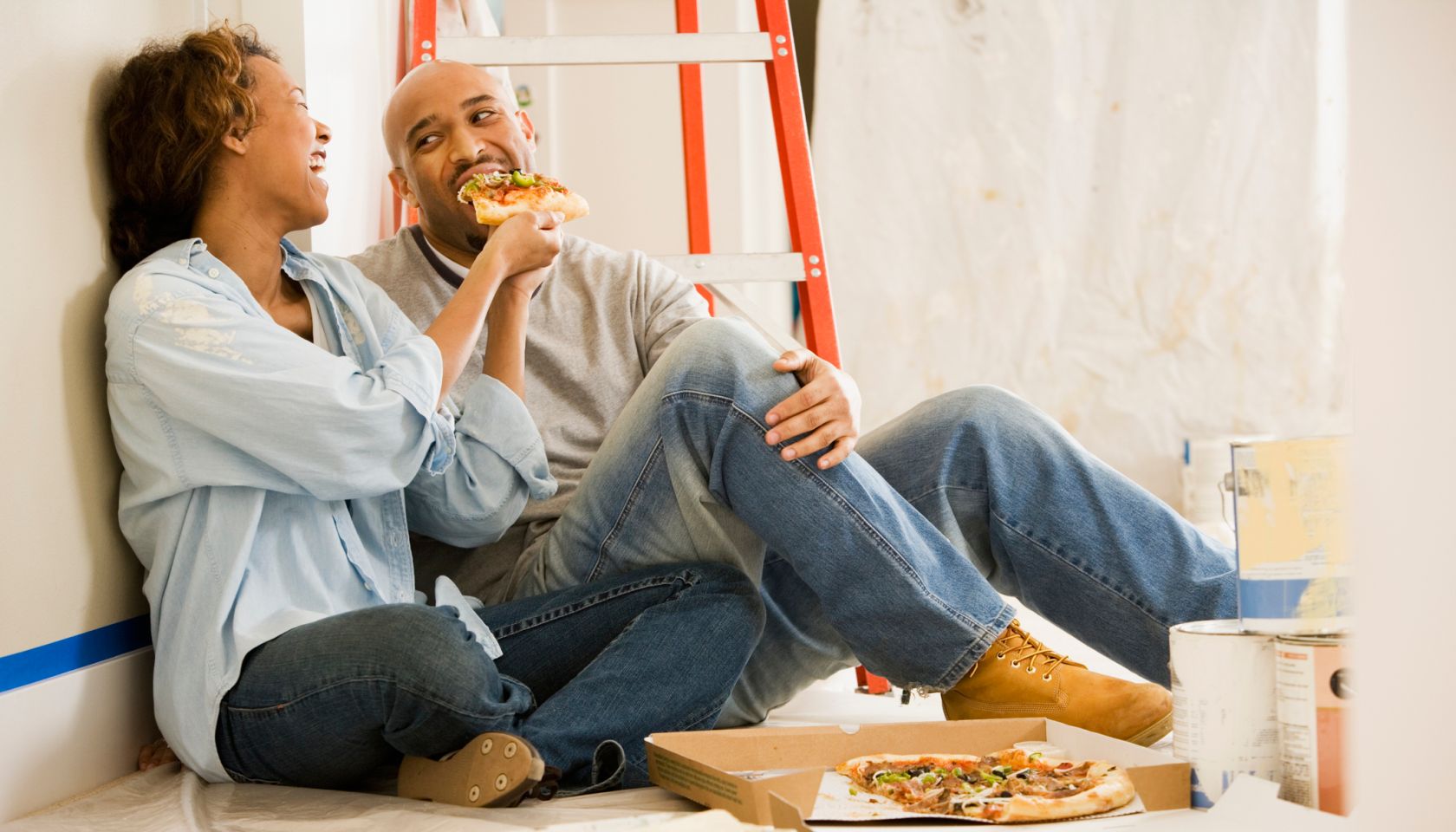 African couple taking lunch break from painting