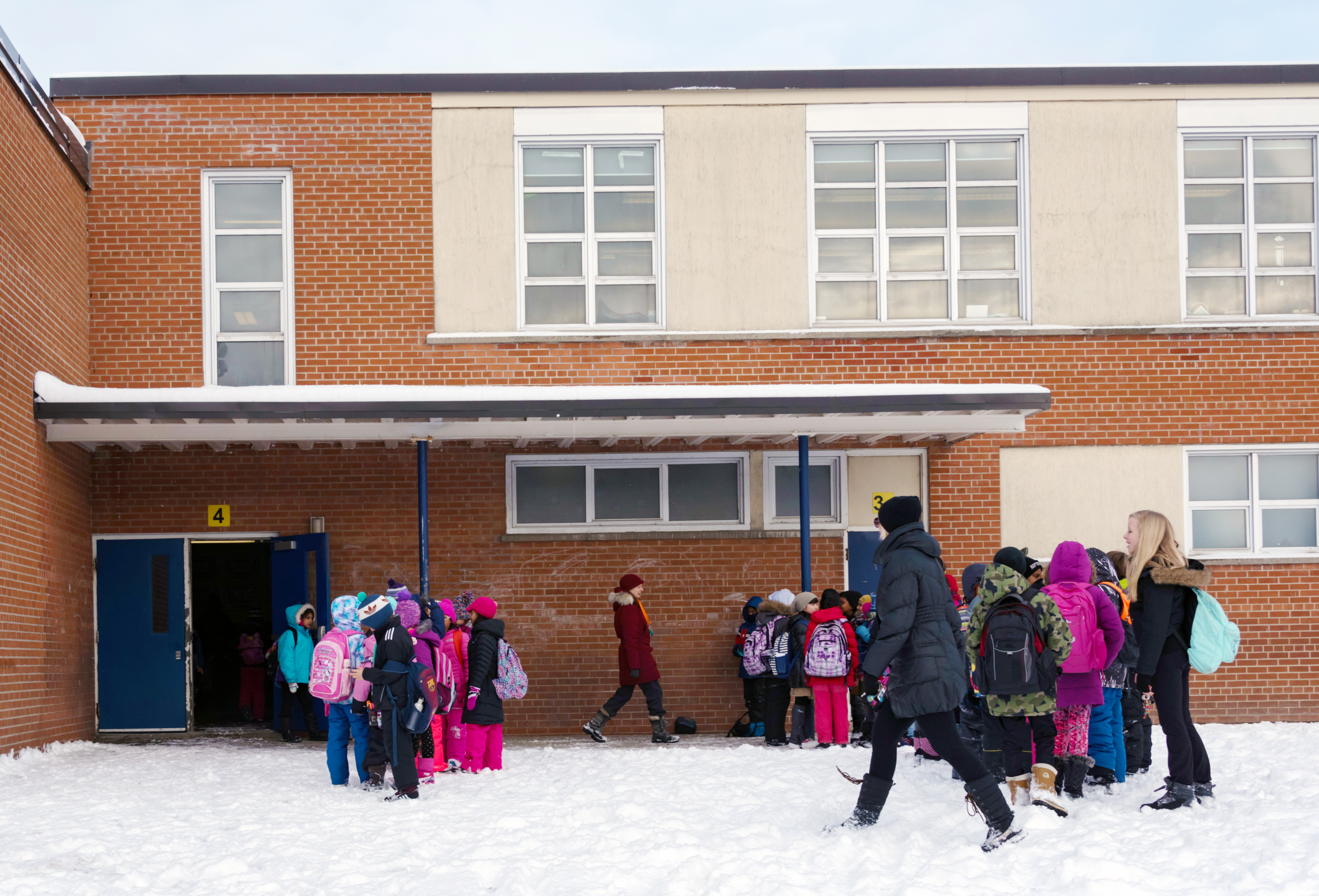 Winter school day: Middle school students waiting to enter...