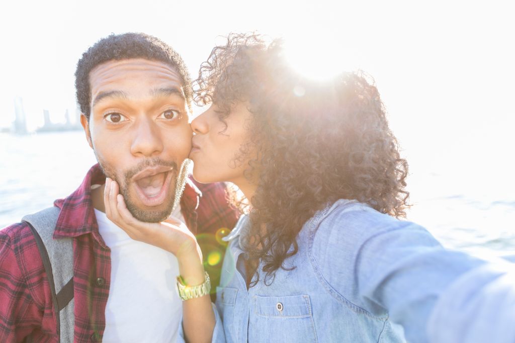 Young man receives thank you kiss from wife on vacation