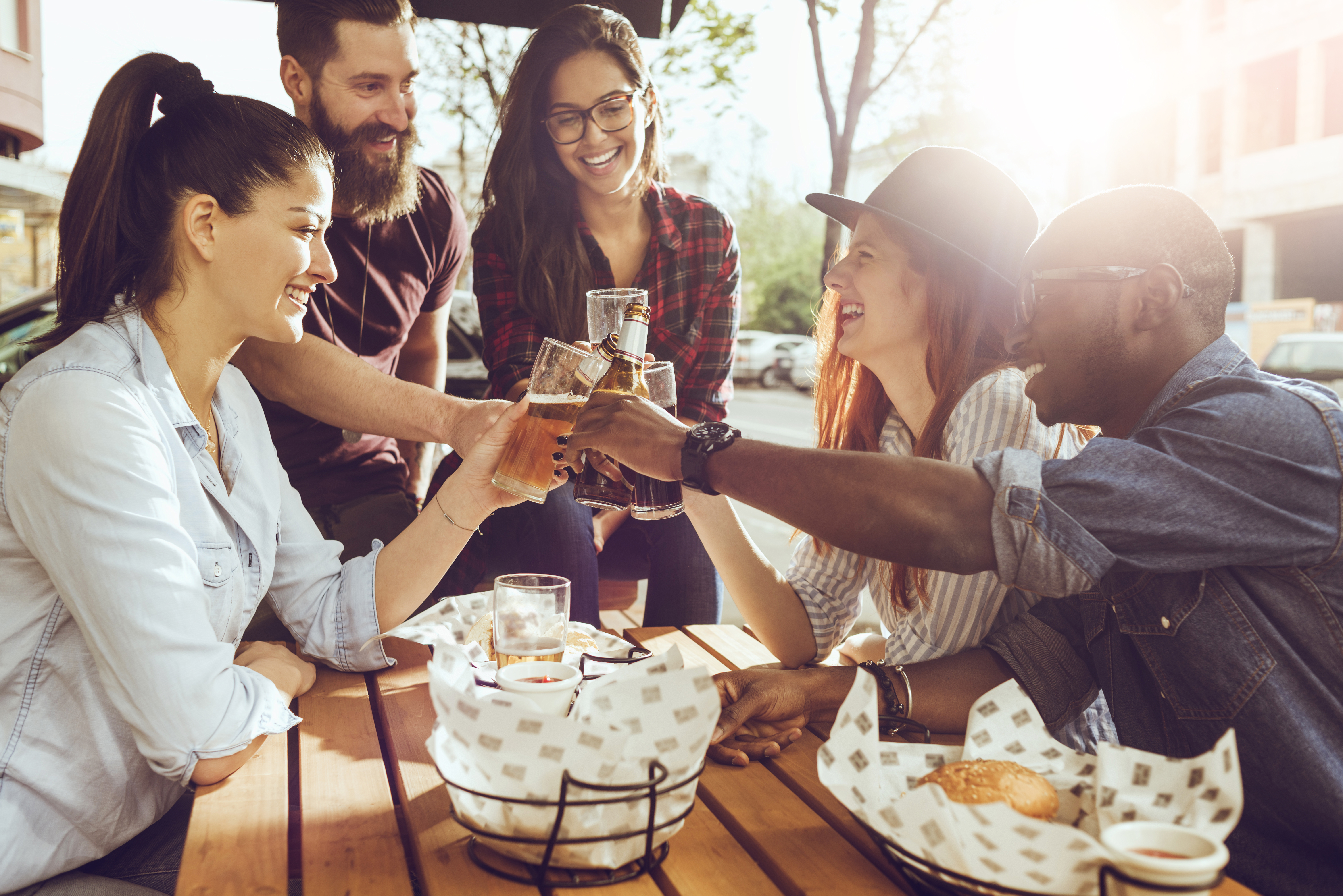cheerful group of friends having fun and clinking their glasses