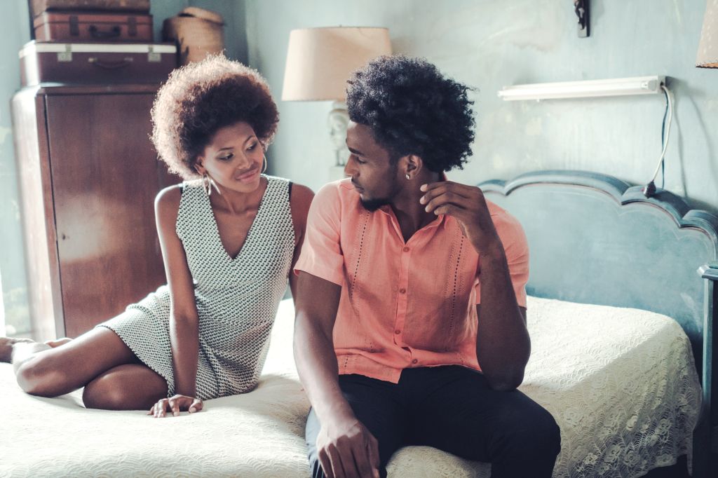Passionate couple relaxing on bed at home
