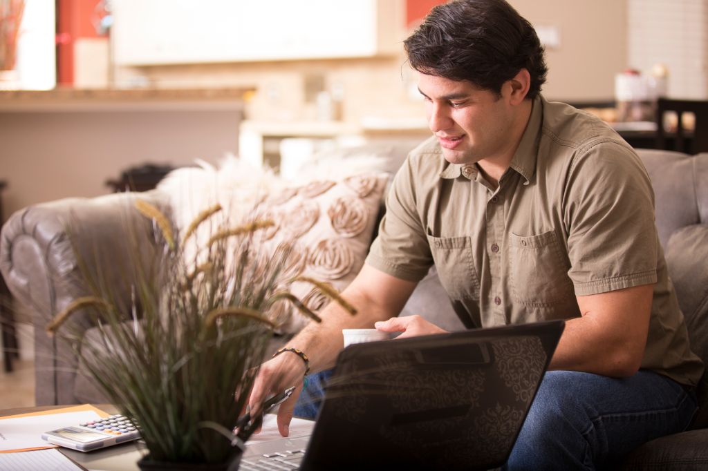 Young adult man working from home.
