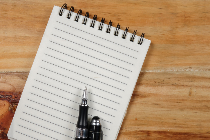 Directly Above Shot Of Note Pad With Pen On Wooden Table
