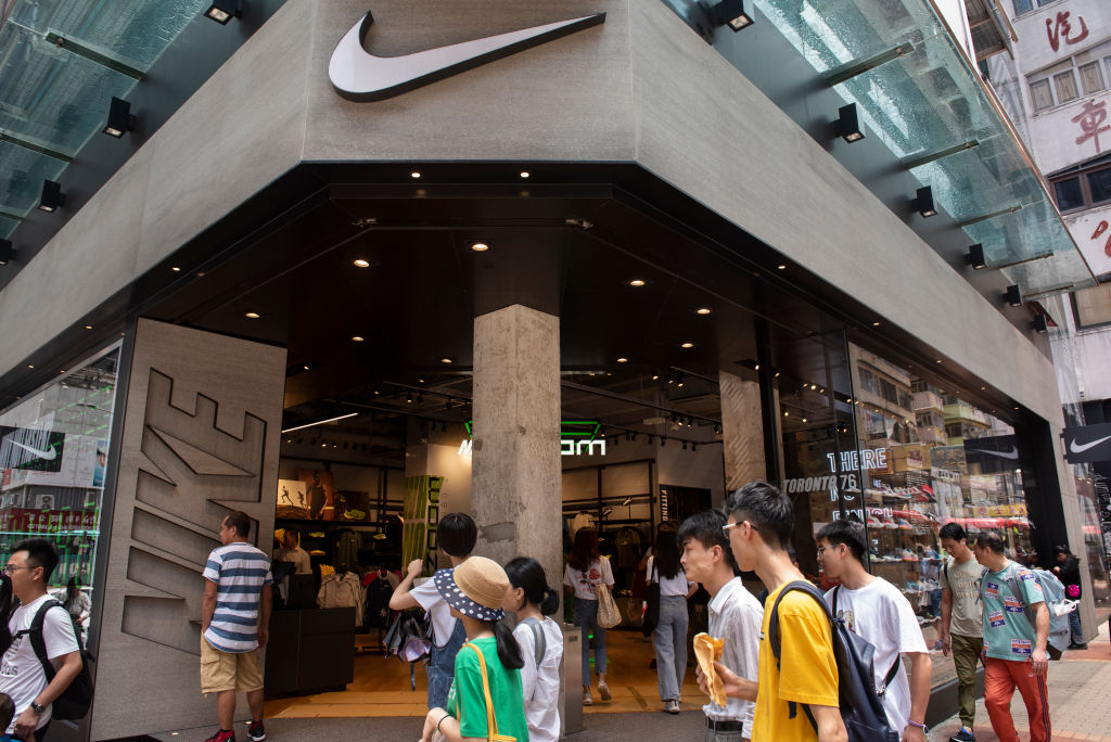 Pedestrians pass by American multinational sport clothing...