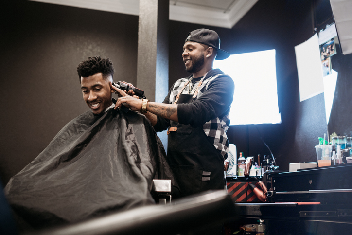 Barber Giving A Haircut in His Shop