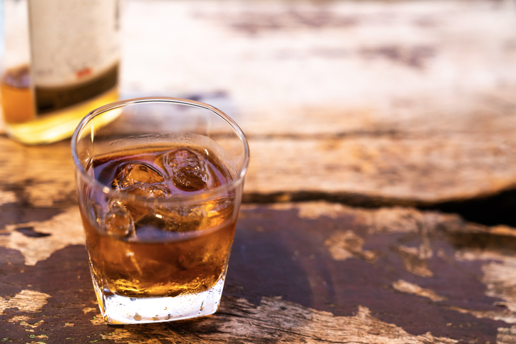 Two rye whiskey cocktail drinks toasted together,Addictive substance
