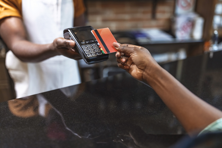 Cropped shot of an unrecognizable woman paying for her purchase by card