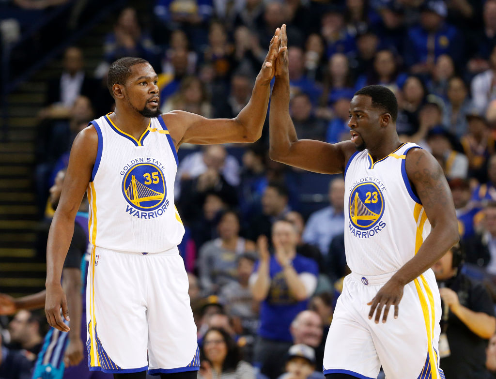Golden State Warriors' Kevin Durant (35) high-fives Golden State Warriors' Draymond Green (23) during their game against the Charlotte Hornets in the first quarter at Oracle Arena in Oakland, Calif. on Wednesday, Feb. 1, 2017. (Nhat V. Meyer/Bay Area News