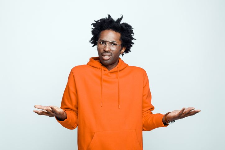 Confused man in orange hoodie