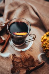Mulled wine in a glass with spices and citrus fruit