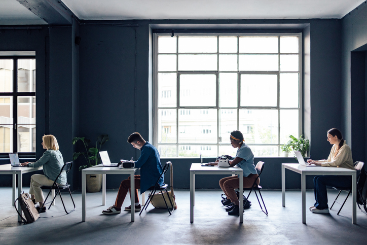 University Students Taking Notes While Sitting In The Classroom