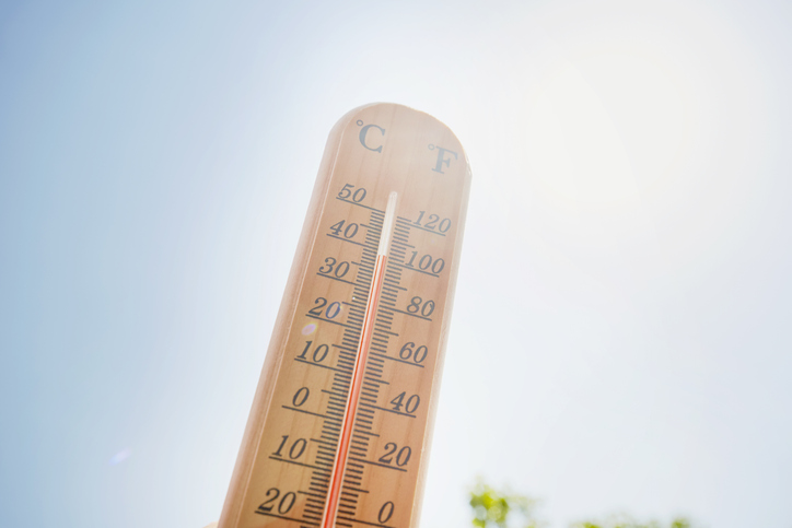 Thermometer against sky and sun
