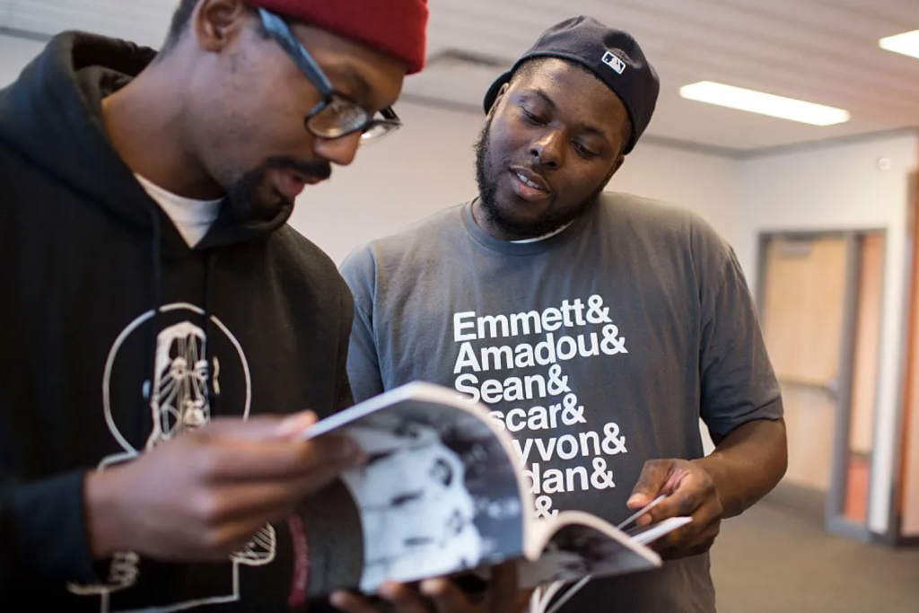 Tory Russell (right) and Damon Davies (left) look through books offered at a “Books and Breakfast” event on Saturday, Jan. 31, 2015, at the Ferguson Community Center in Ferguson, Missouri. The Washington Post / Getty