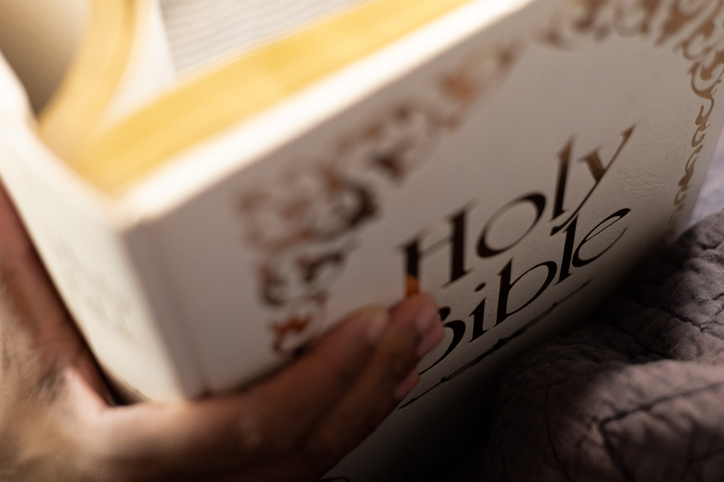 black woman reading old family bible