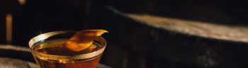 Manhattan Bourbon Whiskey Cocktail In Vintage Crystal Hotel Glass Orange Garnish Atop Wood Barrel