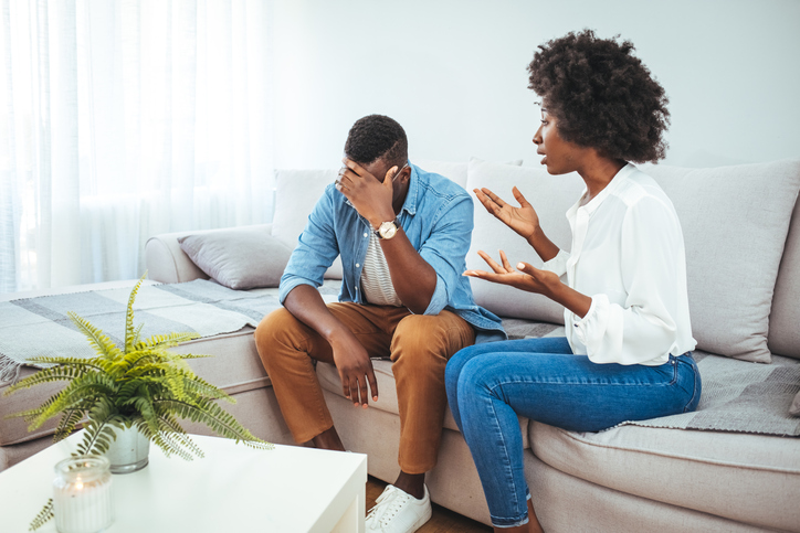 Unhappy young couple sit separate have problems in relationship