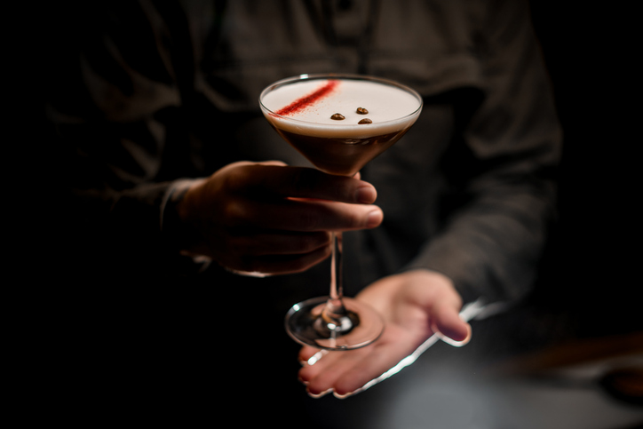 beautiful view on glass with espresso martini cocktail decorated with coffee beans