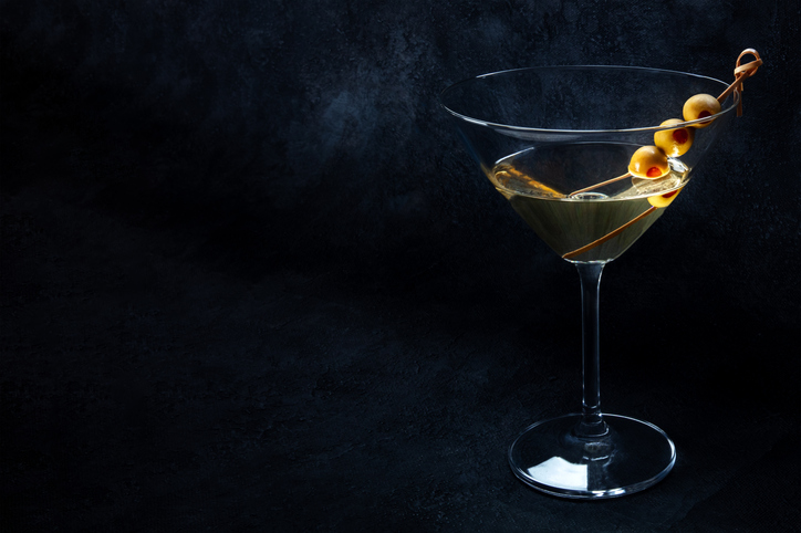 Martini. A glass of dirty martini cocktail with vermouth and olives