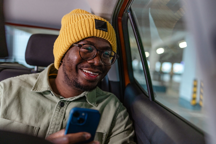 A young man enjoying his ride on the back car seat