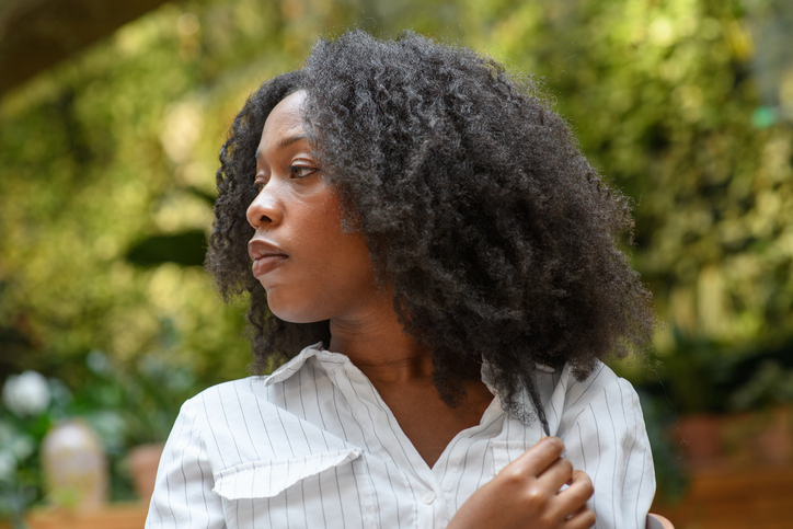 Portrait of a young woman touching her hair
