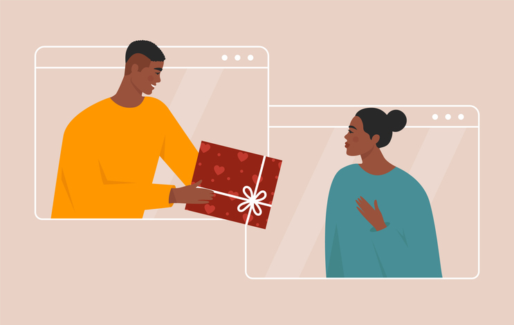 Love online concept. Beautiful young couple celebrating Valentine’s day together, having a video call and giving gifts through a screen. Distant romantic relationship.