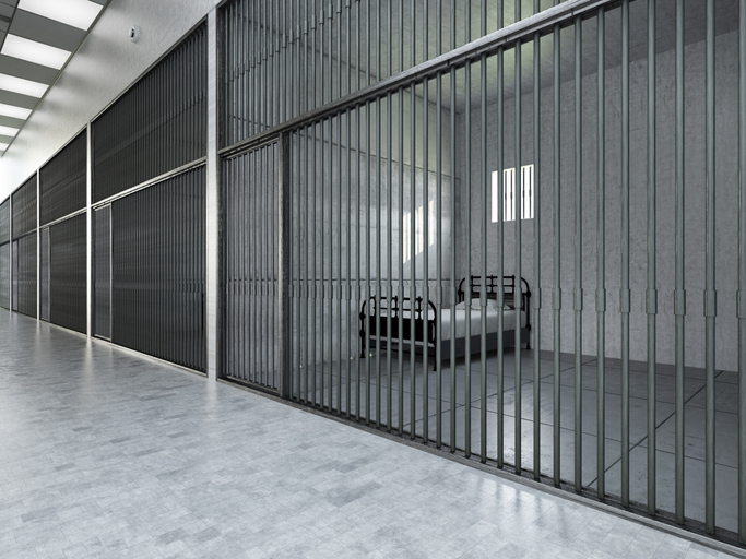 Empty Jail Corridor With Visible Cell Interiors